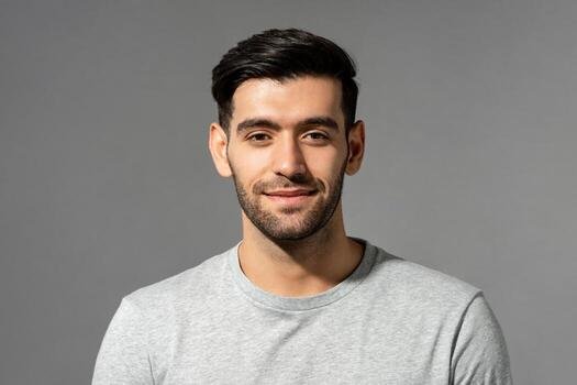 close up portrait of smiling handsome young caucasian man face looking at camera on isolated light gray studio background photo